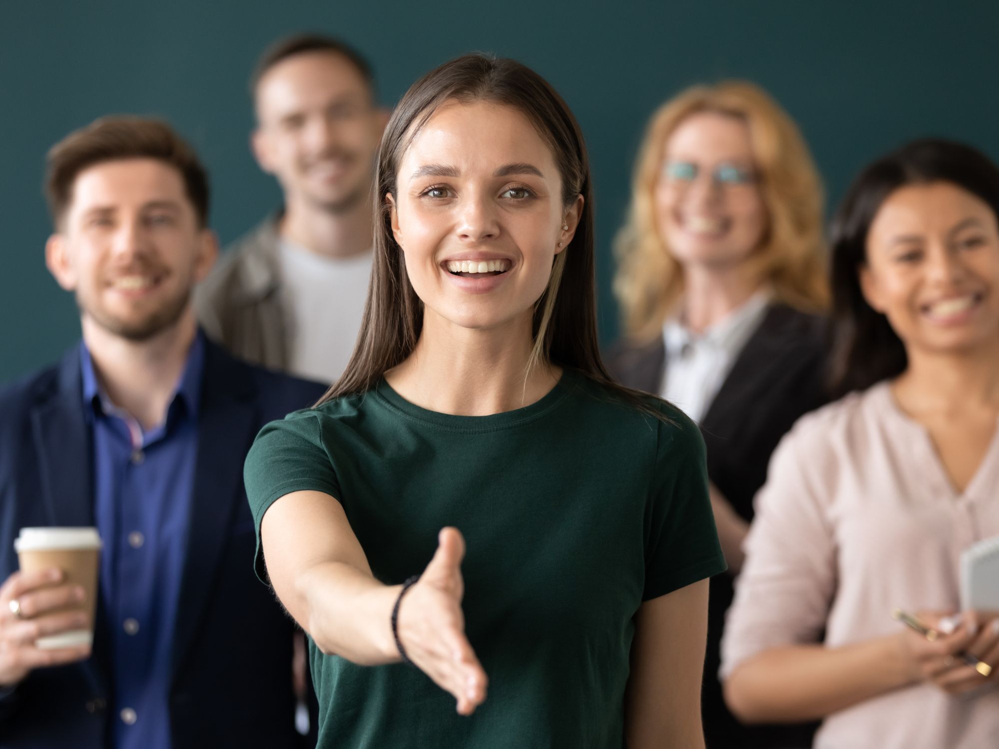 A group of business people standing in front of a blackboard discussing drip hydration and vitamin injection.