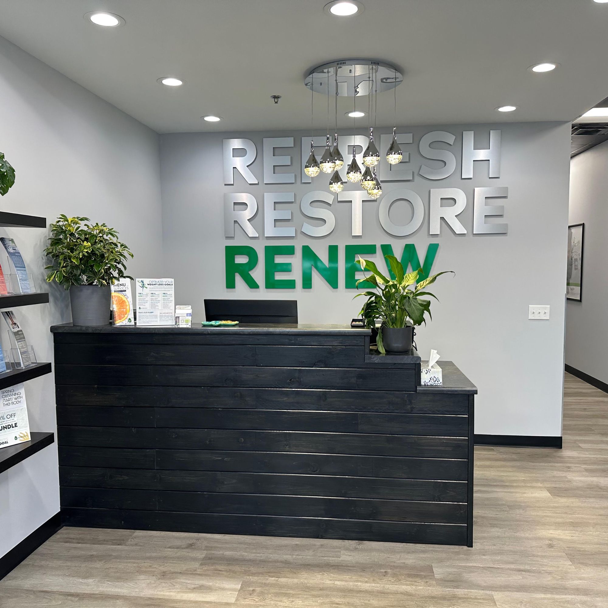 A reception desk offering blood testing services, vitamin injection, and drip hydration in a store.