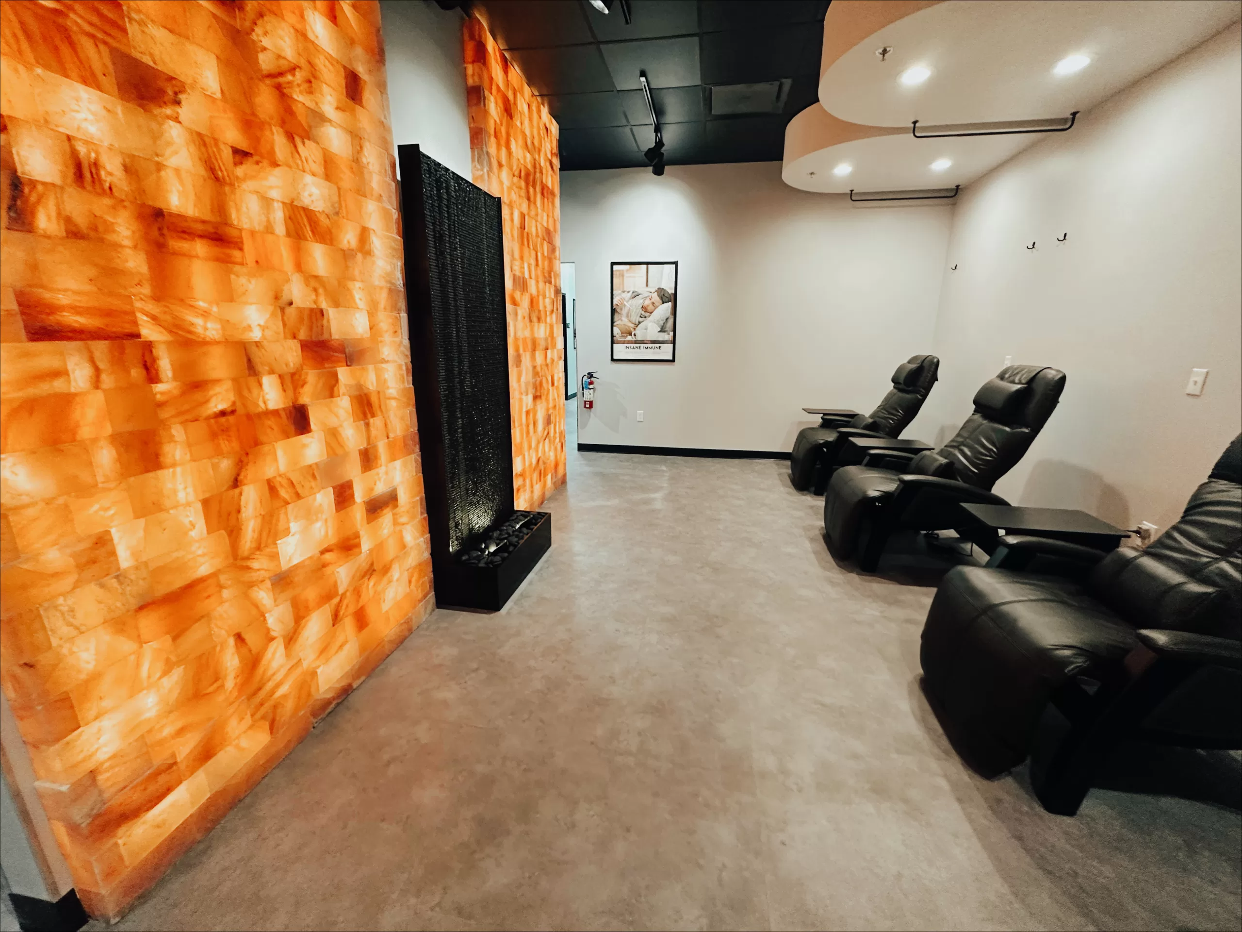 A room with chairs and an orange wall.